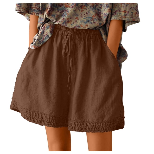 Timegard Womens Plus Size Shorts Cotton Linen Elastic High Waisted Wide Leg Lounge Shorts with Pockets. These casual shorts are shown in a brown tone with a loose fit, elastic waistband, and lace-trimmed hem. Made from a lightweight blend of 95% polyester and 5% spandex, they are breathable and comfortable for spring and summer. The shorts are styled with a tucked-in floral top, highlighting their relaxed and versatile design.
