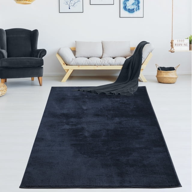 LaDole Rugs 3x10 ft Fluffy Shaggy Area Runner Rug in navy blue displayed in a modern living room setting. The rug features a high-pile texture, offering a plush and inviting feel underfoot. It is machine washable, foldable, and designed for durability, making it suitable for high-traffic areas like hallways, kitchens, and entryways. The room includes a light wood sofa with neutral cushions, a black armchair, and decorative wall art, complementing the rug's elegant design.