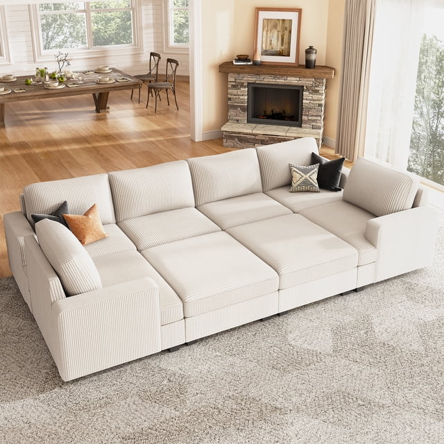 HONBAY Canapé Sectionnel-Lit en Velours Côtelé avec Modules de Rangement Réversibles pour Salon, Beige. Ce Canapé Modulaire Présente un Tissu en Velours Côtelé Beige Doux, une Mousse à Haute Résilience et des Ressorts Serpentins pour un Confort Accru. le design Sectionnel Comprend Deux ottomans de Rangement Spacieux et des Housses Amovibles et Lavables pour un Entretien Facile. le Canapé Se Convertit Sans Effort en Lit, le Rendant Idéal pour Se Détendre, Recevoir Ou Accueillir des Invités d'Une Nuit. Montré dans un Salon Lumineux avec un Foyer et un Coin Repas en Arrière-Plan