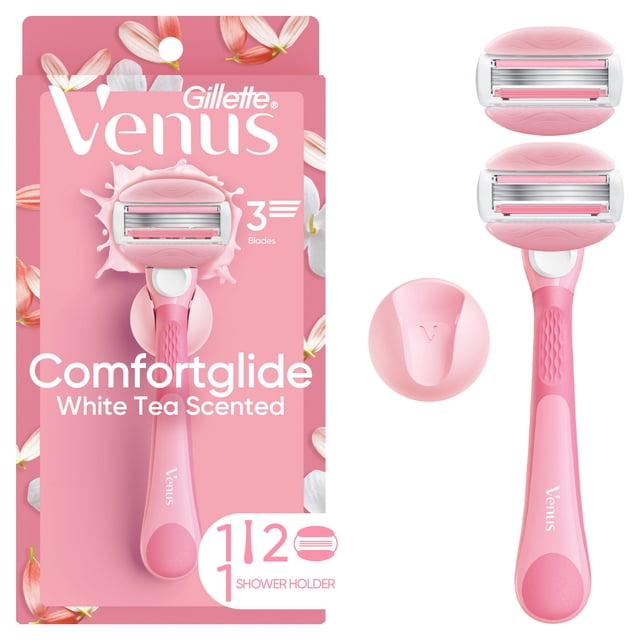 Venus Comfortglide Women's Razor White Tea Scented with pink ergonomic reusable handle, 3-blade cartridge featuring built-in white tea scented gel bars, two additional blade refills, and a pink shower holder with Venus logo, displayed on floral pink packaging and separately.