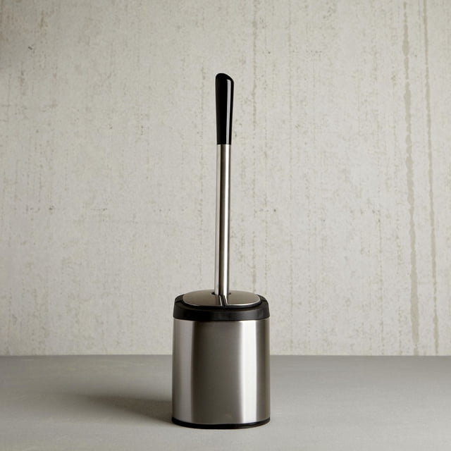 Moda Clam Bowl Brush self-closing toilet brush with slim stainless steel holder, 14.75 x 4.5 in, front-facing view showing closed self-closing lid and narrow cylindrical profile; compact bathroom accessory suitable for corner placement and small powder rooms, brand Moda.
