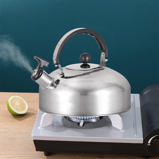 TopLLC Tea Kettle For Stove Top, a stainless steel whistling stovetop tea kettle with an ergonomic silicone-coated handle, shown on a gas stove. The kettle features a functional whistle spout emitting steam, indicating boiling water. Compact and portable design suitable for various stove types, including induction and halogen stoves.