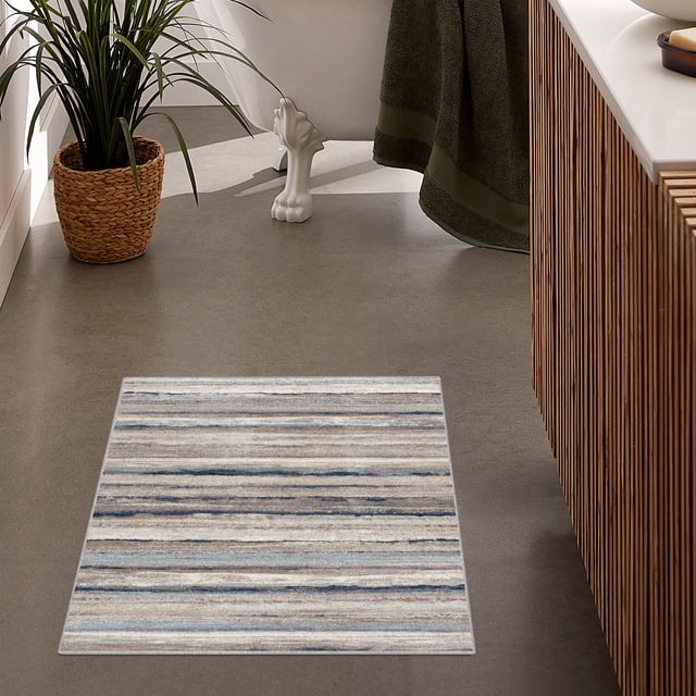 Rug Branch Rimal 2' x 5' (2'3" x 5'1") Blue/Brown Abstract Indoor Doormat Rug displayed in a modern bathroom setting. The medium-pile rug features a contemporary abstract design with blue and brown tones, complementing the neutral decor. Made of 100% polypropylene with a jute backing, it is stain-resistant and suitable for entryways, mudrooms, hallways, and kitchens. The rug is loom-made in Turkey and measures 2' x 5'1".