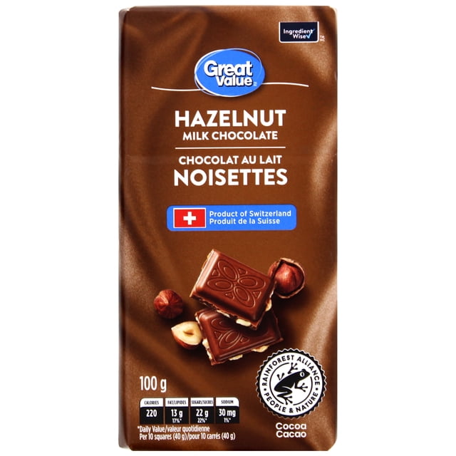 Great Value Hazelnut Milk Chocolate 100 g bar with brown packaging showing the Great Value logo, Swiss product label, and Rainforest Alliance certification, featuring milk chocolate squares with whole and halved hazelnuts, often used for snacking or baking.