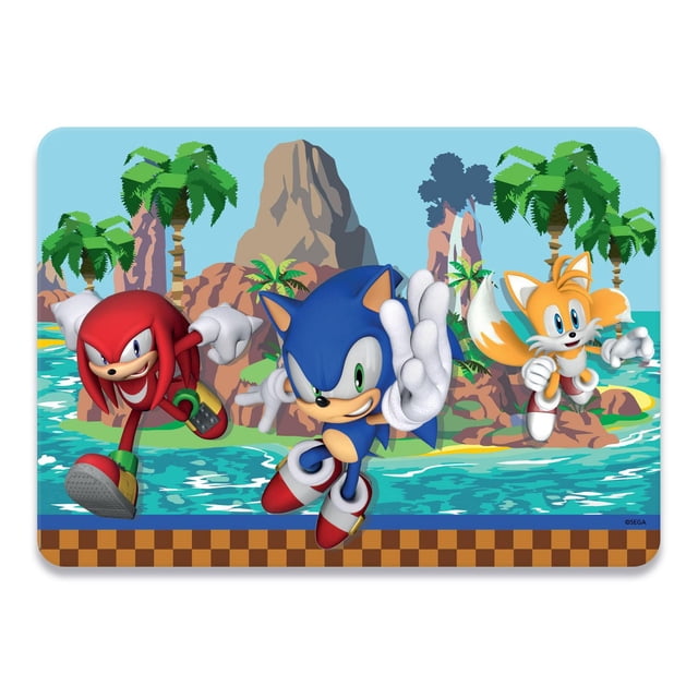 Sonic "Mystic Waterfall" Placemat featuring Sonic the Hedgehog, Knuckles, and Tails in dynamic action poses over a tropical island backdrop with palm trees, rocky cliffs, and blue water, bordered by a brown checkered pattern, made of durable, stain-resistant polypropylene, easy to wipe clean and suitable for children's mealtime or playroom use.