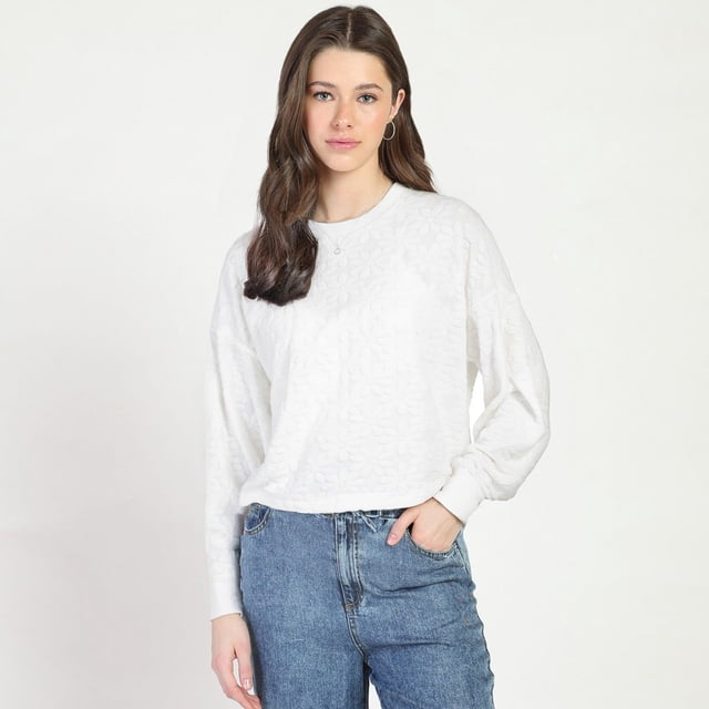 Bloom Girl Long Sleeve Patterned Top in white featuring a soft floral jacquard knit, crew neckline, ribbed trim at neckline, cuffs, and hem, with a relaxed boxy fit, shown with high-waisted blue jeans, ideal as a comfortable layering piece.
