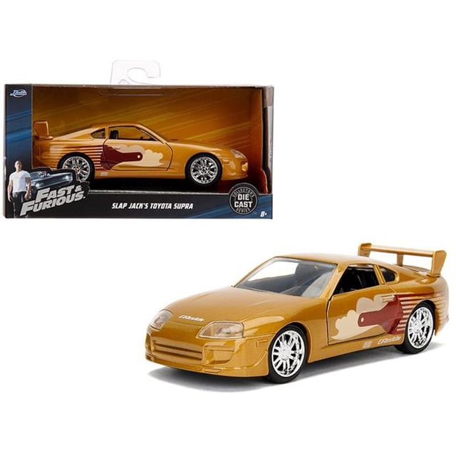 Jada 99542 Slap Jacks Toyota Supra Gold Fast & Furious Movie 1-32 Diecast Model Car. A 1/32 scale diecast replica of Slap Jack's Toyota Supra in gold, inspired by the Fast & Furious movie. Features real rubber tires, opening doors, and detailed interior and exterior. Made of diecast metal with some plastic parts. Approximately 5 inches long. Packaged in a branded box with Fast & Furious graphics.
