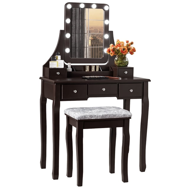 Costway Vanity Dressing Table Set with 10 dimmable bulbs, touch switch, and cushion stool in brown finish. Ideal for makeup and beauty routines, it features five drawers, a detachable organizer, and a spacious tabletop for storing cosmetics and jewelry. Includes a 360° rotating mirror with adjustable LED lighting and a comfortable upholstered stool. Made of MDF and solid pine wood with non-slip foot mats for stability. Suitable for bedrooms, bathrooms, or hallways.