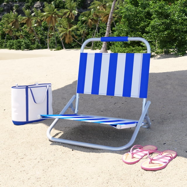 Mainstays Beach Chair, Blue & White Stripes with rust-resistant powder-coated steel frame and foldable lightweight design, placed on sandy beach with palm trees, accompanied by a white and blue tote bag and pink flip-flops, ideal for portable outdoor seating and beach relaxation.
