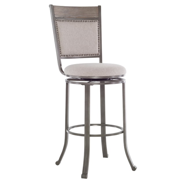 Trager Tabouret de bar, Étain, avec un Cadre en Métal Gris Étain Enduit de Poudre et Quatre Pieds Légèrement Courbés Reliés par un Repose-Pieds Circulaire. Il Présente un Siège Rond en Tissu de performance beige Qui Pivote à 360 Degrés et un Dossier Rembourré avec Placage de Bois Gris Lavé et Garniture de Clous Étain. Conçu pour des Hauteurs de bar de 38 à 42 Pouces, Il Offre un Rembourrage Résistant aux Taches et Facile à Nettoyer.