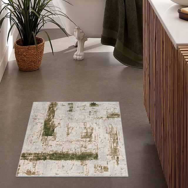 Rug Branch Vogue Collection Modern Abstract Area Rug on a grey bathroom floor, featuring a distressed abstract pattern with green and beige tones on a light background, placed near a wooden slatted vanity and a white clawfoot bathtub with a dark green towel, ideal for indoor high-traffic spaces.