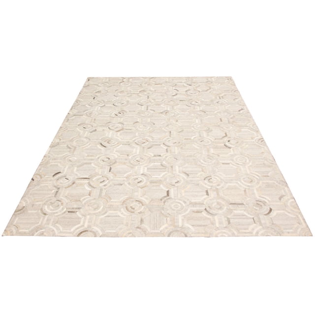ECARPETGALLERY 9'1" x 12'9" contemporary cowhide patchwork handmade area rug in grey featuring geometric circular and linear patterns with natural leather texture and subtle color variations, suitable for southwestern or modern minimalist décor in living, dining, or bedroom spaces.
