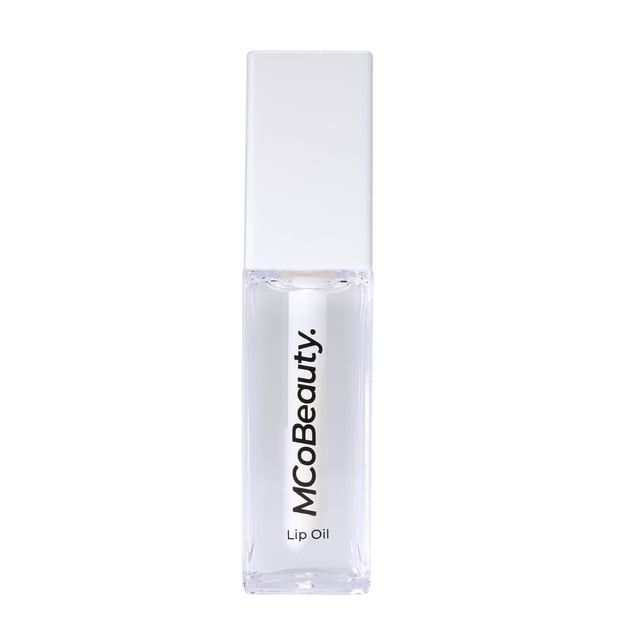 MCoBeauty Lip Oil Hydrating Treatment in a clear rectangular bottle with white cap and black vertical text, offering nourishing lip balm hydration and a high-shine finish ideal for day and night lip care.