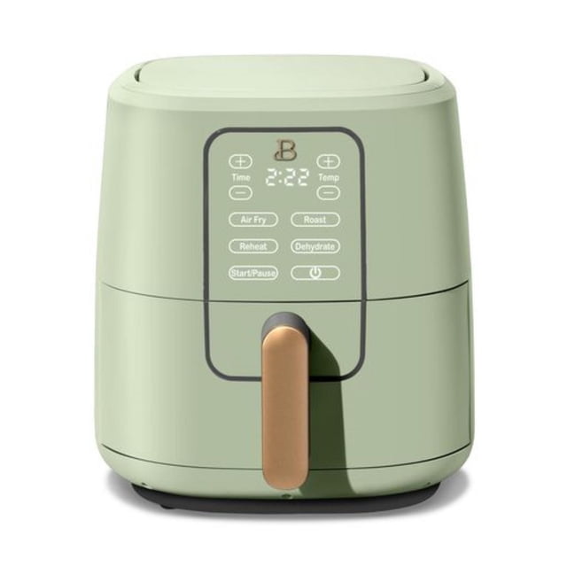 Beautiful 6-Quart Touchscreen Air Fryer by Drew Barrymore in sage green with a front-facing digital touchscreen display showing time and temperature controls, gold handle, and rounded compact design for air frying, roasting, reheating, and dehydrating meals in a small appliance kitchen setting.