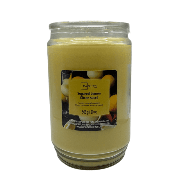 MAINSTAYS PL Sugared Lemon Scented Single-Wick Glass Jar Candle, 20 oz, containing yellow paraffin wax in a clear glass jar with a label depicting lemons and bilingual text, designed for a clean, even burn and fresh citrus scent suitable for home décor and scented jar candles.