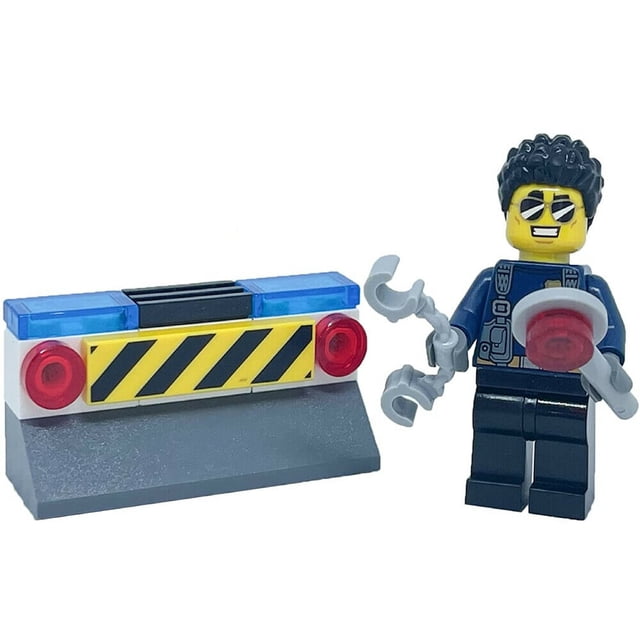 LEGO City: Duke Detain Detective with Handcuffs - Foil Pack featuring a multicolour LEGO figure of Duke Detain in a police uniform holding handcuffs and a red signal disc. The set includes a small barricade with red and blue lights and a yellow caution stripe. Packaged in a clear polybag, the figure is less than 2 inches tall and suitable for ages 6 and up due to small parts.