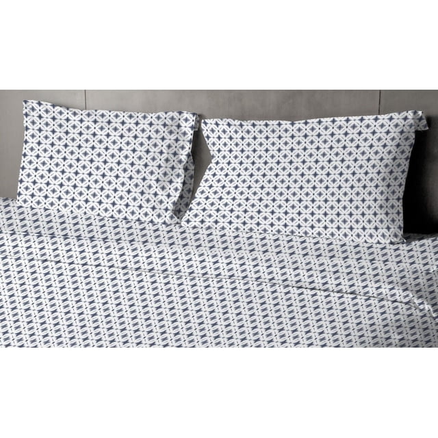 Johnson Home 200 TC Bed Sheet Set with printed cotton sheets featuring a navy blue geometric pattern on white, including a flat sheet and two pillowcases displayed flat on a grey surface, crafted from breathable cotton for softness and year-round comfort, also suitable for guest bedding or decorative layering.