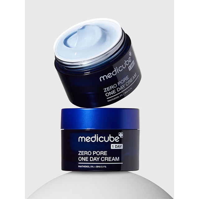 Medicube Zero Pore One Day Cream 50 ml, un Hydratant Léger pour le Visage dans un Pot Bleu Élégant avec Couvercle Assorti, Formulé pour Lisser les pores, Améliorer la texture de la Peau et Offrir une Hydratation Durable. la Crème Est Exposée avec Son Couvercle Enlevé, Mettant en Valeur une Formule Bleue Douce. Parfait pour les routines Quotidiennes de Soins de la Peau.