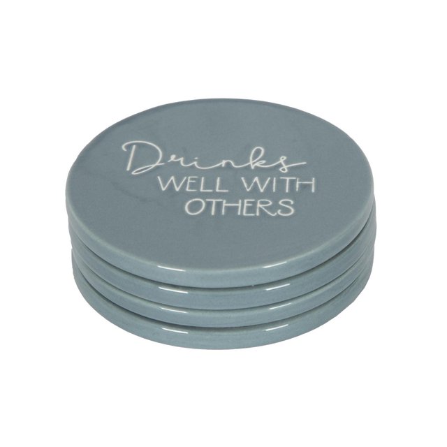 Linden Porcelain 4 Piece Coaster Set with Blue Finish showing a stack of four round blue porcelain coasters, each 3.9 inches in diameter with cork bottoms, the top coaster featuring the phrase 'Drinks Well With Others' in white script, designed to protect tabletops from spills and suitable for adding a decorative touch to dining and entertaining areas.