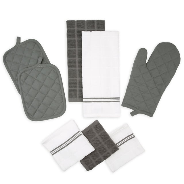 Mainstays 8 Pack Kitchen Set in gray with two quilted pot holders, one quilted oven mitt with polyester fill for heat protection, two white kitchen towels with gray stripes, and three dishcloths in gray and white featuring a grid texture, arranged on a white background. This 100% cotton set is also suitable for general kitchen cleaning tasks.