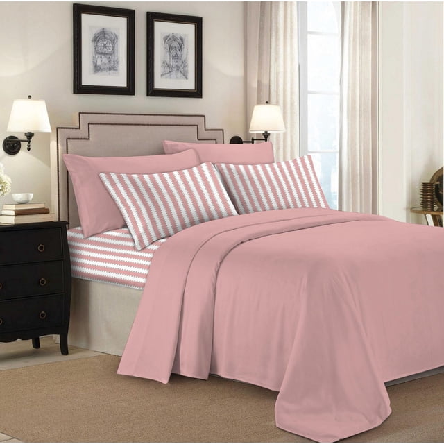 Johnson Home 200 TC Bed Sheet Set - Printed Cotton Sheets on a queen bed with solid dusty pink flat and fitted sheets and pillowcases featuring white and dusty pink zigzag stripes. The breathable cotton fabric ensures year-round comfort. The bed has a beige upholstered headboard with nailhead trim, black nightstands with lamps, neutral curtains, and framed architectural prints on the wall.