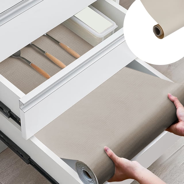 EGNMCR Kitchen Gadgets, Kitchen Accessories Refrigerator Liners measuring 59 x 17.7 inches, shown in a light brown color. The non-adhesive, non-slip, and waterproof liner is being unrolled into a kitchen drawer. The liner is used to protect surfaces from stains, scratches, and moisture. The drawer contains neatly organized utensils and a storage container, demonstrating its use as a shelf liner for kitchen cabinets, drawers, and refrigerators. Made of durable plastic, it is easy to clean and can be cut to fit various sizes and shapes.