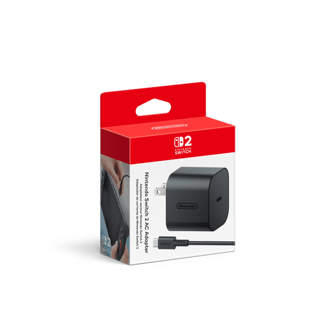 Nintendo Switch™ 2 AC Adapter in retail packaging with red and white box showing the Nintendo Switch 2 logo, a black replacement charger with detachable cable, and a side image demonstrating connection to the Nintendo Switch 2 console or dock, suitable as a power supply replacement.