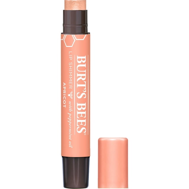 Burt’s Bees 100% Natural Lip Shimmer in Apricot, a peach-coloured lip balm stick with dark brown base and removed cap, showing shimmering lip colour enriched with peppermint oil, shea butter, and beeswax for natural moisturizing and subtle glow, suitable as a natural lip gloss alternative.