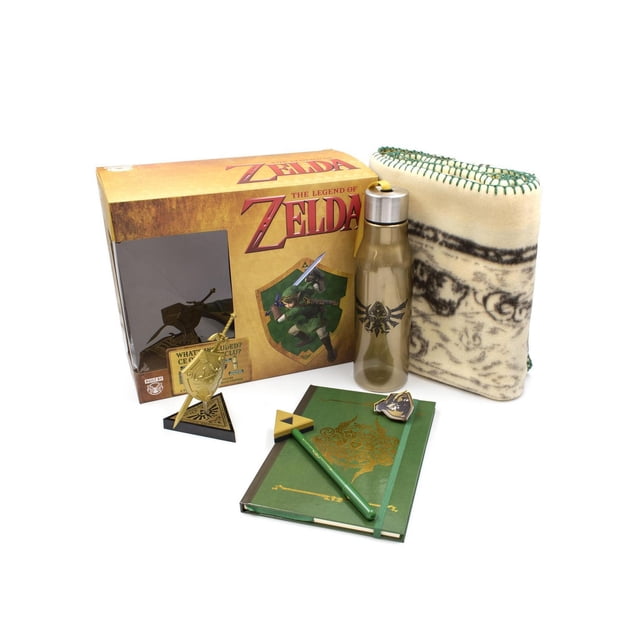 The Legend of Zelda Blanket Loot Box featuring a folded cream blanket with green stitching, an olive translucent water bottle with Hylian crest, a green notebook with gold detailing, matching pen, shield pin, and a gold vinyl figure of Link's sword and shield beside the collector box.