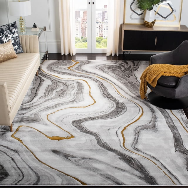 SAFAVIEH Craft Angjelko Abstract Area Rug featuring swirling grey and gold abstract patterns on a soft synthetic pile, placed in a contemporary living room setting between a beige sofa and a dark grey swivel chair with a mustard throw, suitable for enhancing modern decor and comfort.