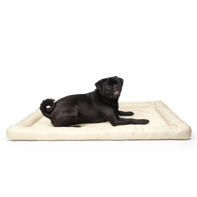 One Paw Cooling Dog Mat With Cushion in beige, large 36x23 inch water-resistant dog bed with soft polyester fiber filling, shown with a black pug resting on it. Designed for pet cooling and comfort, lightweight for indoor or outdoor use, also suitable as a portable pet resting mat.