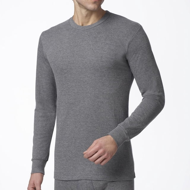 Stanfield's Essentials Men's Two Layer Thermal Long Sleeve Shirt in grey, shown front-facing on a male model from neck to hips, made of a 50% cotton, 50% polyester blend with ribbed crew neck and cuffs, flatlock seams, and a standard fit for unrestricted arm movement, suitable as a warm, lightweight thermal base layer for winter.
