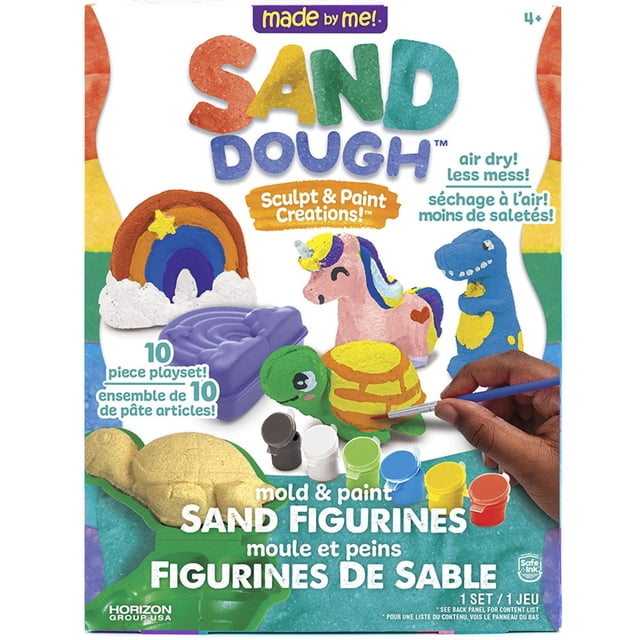 Made By Me! Sand Dough Sculpt & Paint Creations! Mold & Paint Sand Figures front-facing view of kit contents: four sand dough molds (T‑Rex, turtle, rainbow, unicorn), 12 oz. sand dough, three sculpting tools, two paintbrushes and six paint pots (2 yellow, 1 purple, 1 pink, 1 light blue, 1 lime green) on a tabletop craft surface; ages 4+. Often used as party décor or small craft gifts.