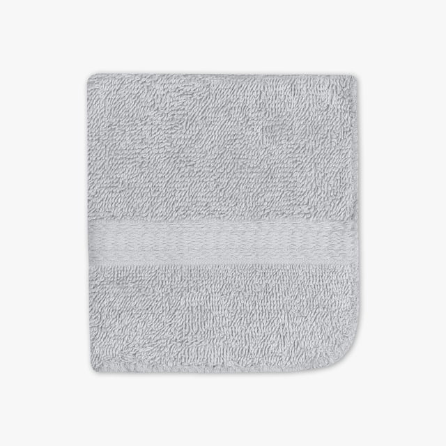 Mainstays Basic Washcloth in grey, 12 by 12 inches, made of 100% cotton terry fabric with a looped texture and a horizontal woven band, designed for absorbent daily bathroom use and suitable for gentle face cleansing.