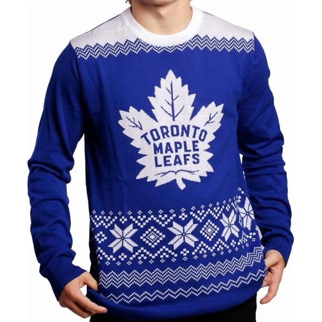 Men's Toronto Maple Leafs NHL Big Logo Gradient Ugly Knit Sweater featuring a bold white team logo on a blue background with gradient details. The sweater has festive snowflake and geometric patterns, ribbed cuffs, collar, and hem for a secure fit. Ideal for game days, holiday parties, or casual winter wear.