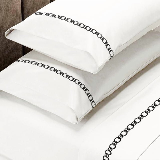 Johnson Home 300 Thread Count Egyptian Cotton Sheet Sets with Embroidery Details showing white pillowcases and sheets with a black embroidered chain-link border, made from breathable, all-season Egyptian cotton with a 300-thread count sateen weave, suitable for adding elegant detail to bedroom bedding.