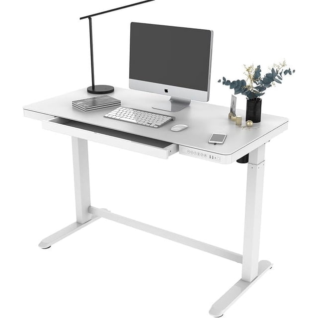 47" x 24" Electric Standing Desk with Glass Tabletop and Drawer by PrimeCables, shown in white. Features a height-adjustable design ranging from 28.3 to 47.6 inches, a spacious glass surface for multiple devices, and an embedded drawer for storage. Includes a control pad with four memory pre-settings, USB charging ports, and an anti-collision function for safety. Ideal for ergonomic sit-stand work setups.