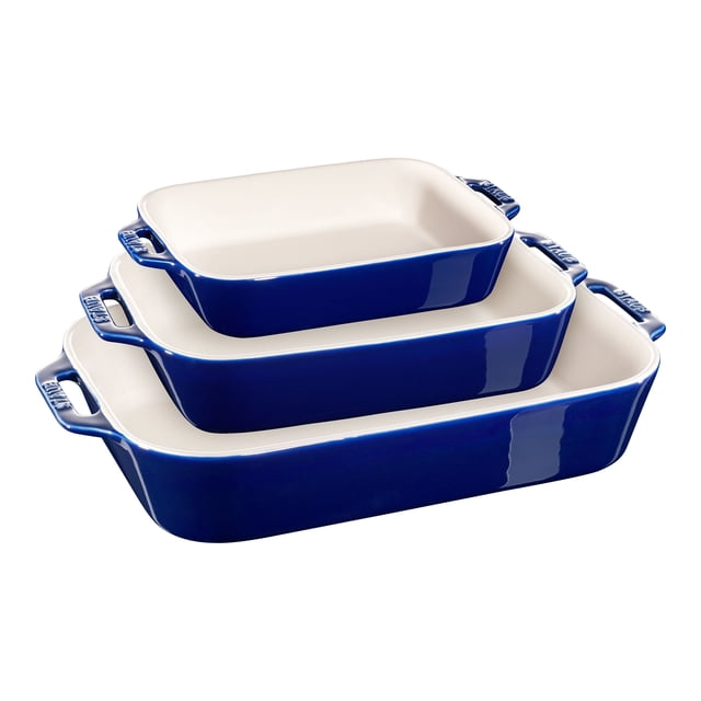 STAUB Ceramique Rectangular Baking Dish Set Dark Blue 3 Piece, featuring three nesting rectangular dishes with a vitreous porcelain-enamel finish. The set includes a 7.5 x 6-inch dish (1.1 liters), a 10.5 x 7.5-inch dish (2.4 liters), and a 13 x 9-inch dish (4.5 liters). These stoneware dishes are highly scratch-resistant, retain heat well, and transition beautifully from oven to table. Designed with large, comfortable handles for easy maneuvering, they are microwave, freezer, broiler, and oven safe up to 300°C/570°F, and dishwasher safe. Shown in a vibrant dark blue exterior with a white interior.