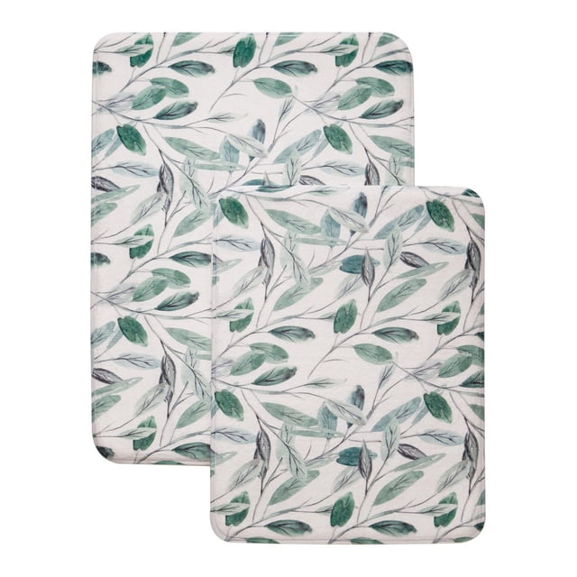 Mainstays Memory Foam Bath Mat Set with two cushioned mats featuring a green and gray leafy botanical pattern on white polyester, sized 20 by 30 inches and 17 by 24 inches, with memory foam padding and non-slip backing for bathroom comfort and safety.