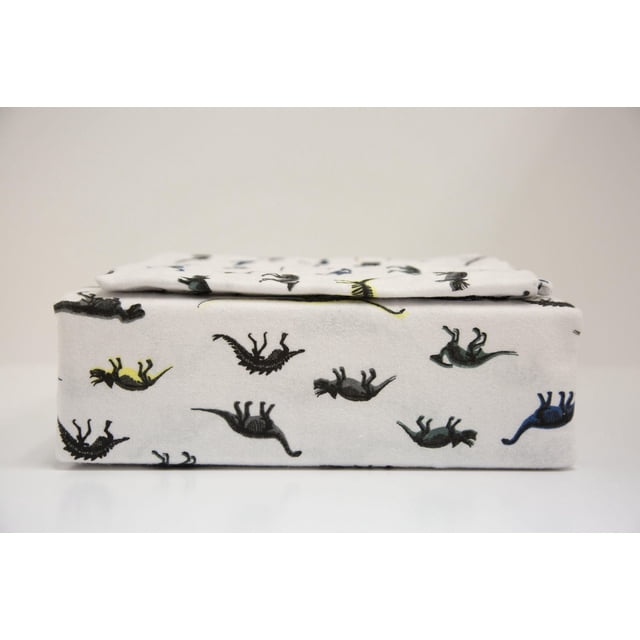 Johnson Home 200 TC Bed Sheet Set - Printed Cotton Sheets folded, featuring white breathable cotton fabric with small dinosaur prints in black, yellow, blue, and green, offering softness and durability suitable for year-round bedding.