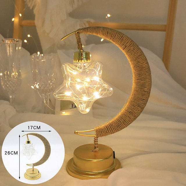 RKSTN Night Light LED Decorative Light Star Light Wrought Iron Night Light featuring a crescent moon-shaped wrought iron frame wrapped in jute, holding a star-shaped LED light with warm illumination. The lamp is displayed on a gold-toned base, suitable for nurseries, bedrooms, or as a decorative piece. Dimensions are 26 cm in height and 17 cm in width.