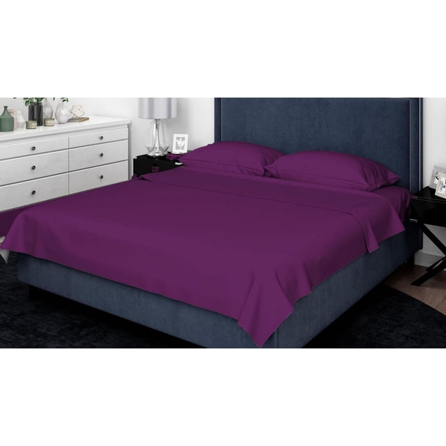 Johnson Home 300 Thread Count Combed Egyptian Cotton Sheet Sets in deep purple on a navy blue upholstered bed with nailhead trim, including a flat sheet and two pillowcases, set in a modern bedroom with white dresser and black nightstand.