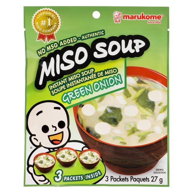 Marukome Instant Miso Soup (Green Onion) package with green background featuring a cartoon character holding three bowls of soup, highlighting no MSG added and three 27 g packets inside, with a serving suggestion of miso soup containing green onions in a red bowl, suitable for quick and authentic Japanese soup preparation.
