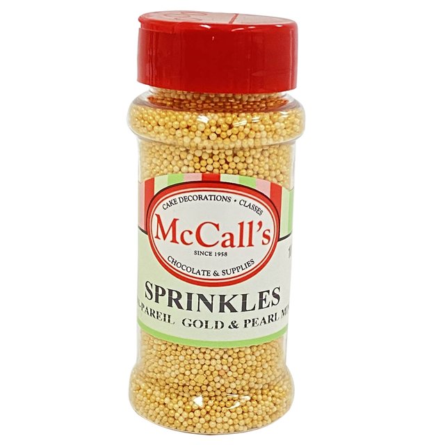 SPRINKLES NON PAREIL GOLD & PEARL MINI 100 g by McCall's Bakers Warehouse, packaged in a clear plastic jar with a red lid, containing gold and pearl mini non pareils. Perfect for decorating cakes, cookies, cupcakes, chocolates, and ice cream toppings.