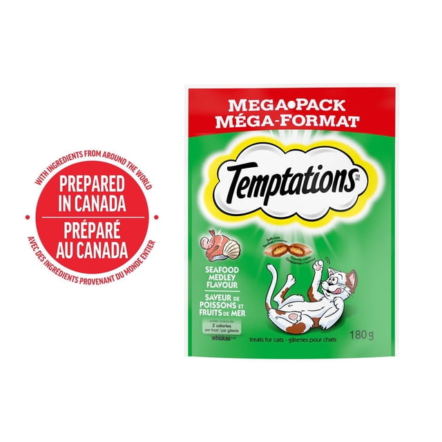 Temptations Seafood Medley Flavour Soft & Crunchy Adult Cat Treats mega-pack 180g pouch with green and red packaging featuring a playful white and grey cat, seafood ingredient icons, and bilingual English-French text. These nutritionally balanced soft and chewy cat treats are prepared in Canada and suitable for daily feeding.
