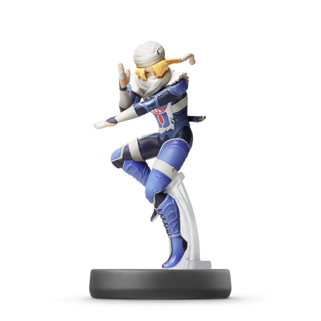 amiibo - Sheik - Super Smash Bros. Series figure depicting Sheik in a crouched ninja pose wearing a blue and white costume with bandages and a white head wrap, standing on a black circular base with clear support, compatible with Nintendo Switch and other systems for unlocking in-game extras.