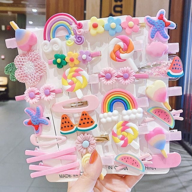 28 PCS Baby Girls Hair Clips, Colourful & Cute Hair Accessories in multicolour. A set of 28 hair clips featuring playful designs like rainbows, flowers, lollipops, and watermelons in pink, purple, and yellow themes. Made from high-quality resin and plastic, these clips offer a comfortable fit with a strong grip, suitable for babies, toddlers, young girls, and teens. Ideal for everyday wear or special occasions.