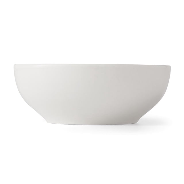 Mainstays Glazed White Stoneware Round Dinner Bowl, 6.1 inches, shown in a centered side profile on a white background. The bowl has a smooth glazed white stoneware finish with a minimalist round shape and gently sloping sides. Dishwasher safe and ideal for serving soups, cereals, desserts, or small salads.