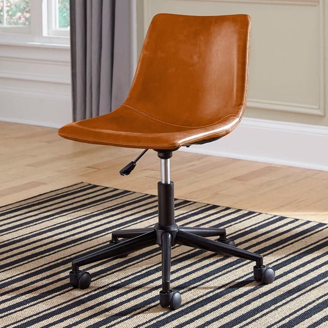 Heavenly Collection Ergonomic Office Chair for Home Office and Workstation with mid-high back brown faux leather seat, adjustable height lever, and black metal base with caster wheels on a striped rug over hardwood floor near window with gray curtains, ideal for ergonomic support and creative desk setups.