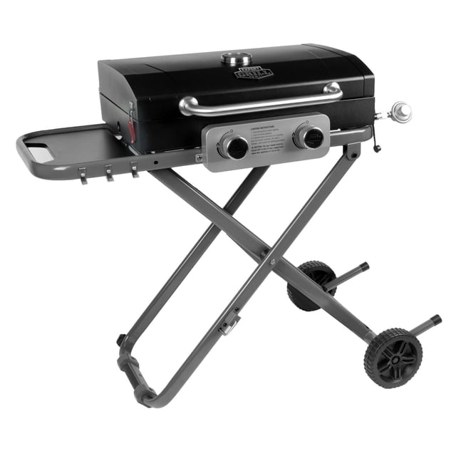 Expert Grill 2 Burner Foldable Propane Gas Grill in black with 20,000 BTU heat, 320 square inch porcelain coated steel cooking surface, two stainless steel control knobs, foldable X-shaped gray metal legs, side tray, and two wheels for portable outdoor cooking.